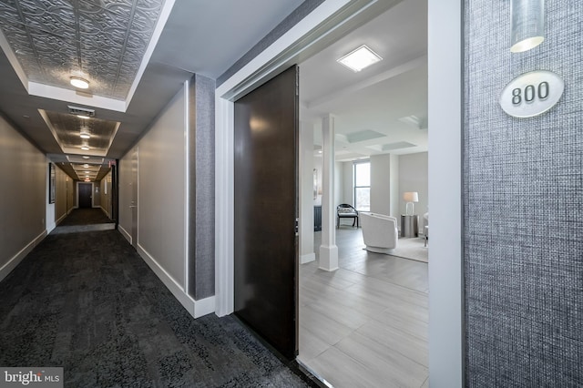 hallway with a tray ceiling