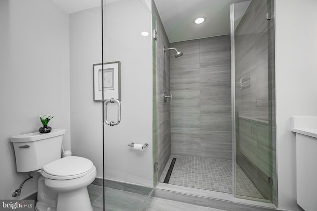 bathroom featuring walk in shower and toilet