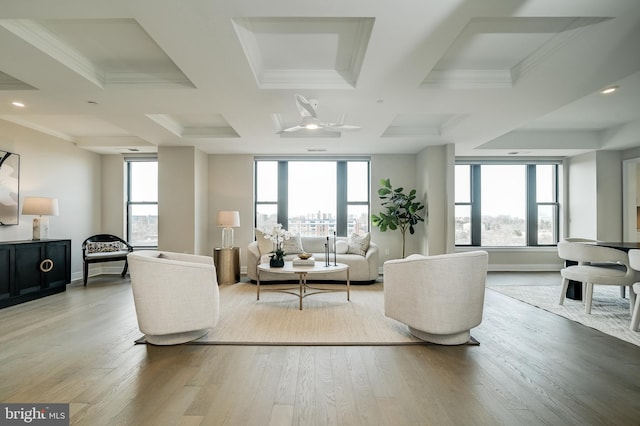 living room with coffered ceiling, hardwood / wood-style flooring, beam ceiling, and crown molding