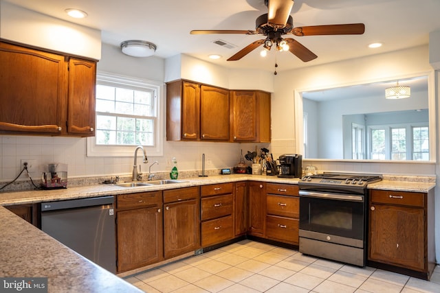 kitchen with dishwasher, stainless steel gas stove, sink, and plenty of natural light