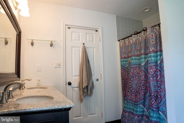 bathroom with curtained shower and vanity