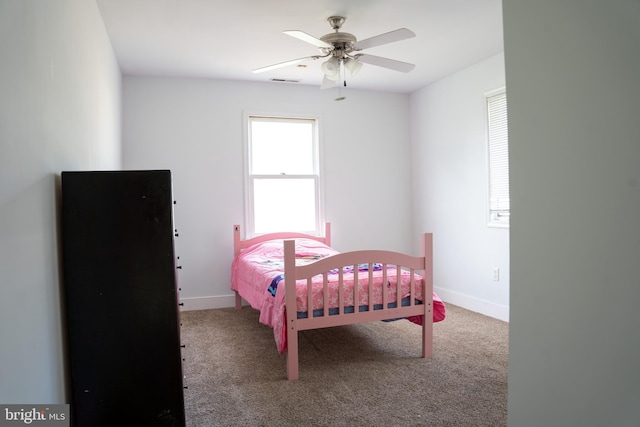 bedroom featuring ceiling fan and carpet