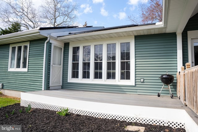 view of side of home featuring a wooden deck