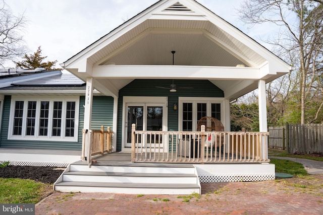 back of house featuring ceiling fan, french doors, covered porch, and solar panels