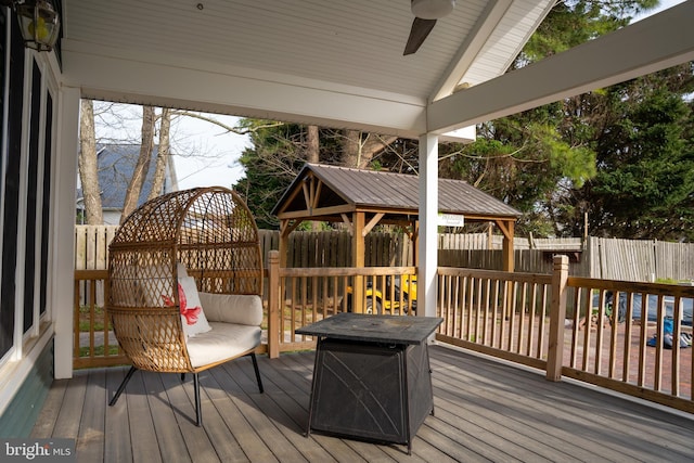 wooden terrace with ceiling fan and a gazebo