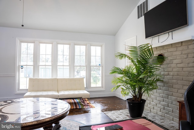 living room with vaulted ceiling and hardwood / wood-style flooring