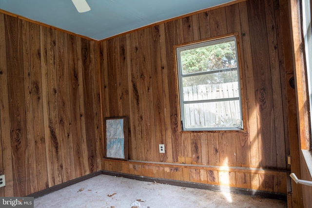 spare room featuring wooden walls