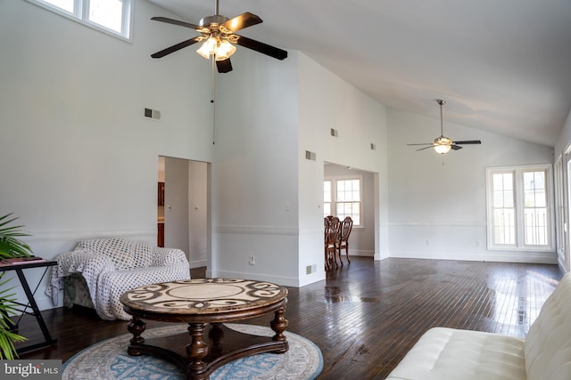 living room with ceiling fan, dark hardwood / wood-style floors, and high vaulted ceiling