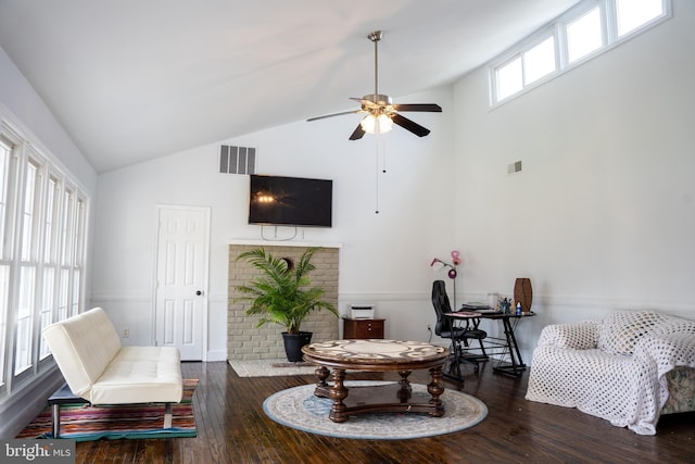 living area with dark wood-type flooring, high vaulted ceiling, and ceiling fan