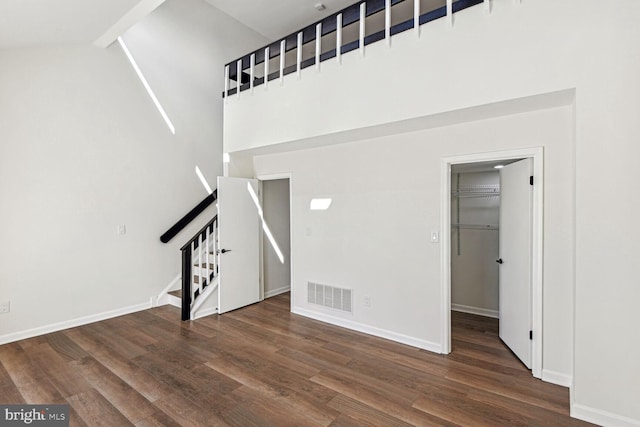 interior space with hardwood / wood-style flooring and high vaulted ceiling