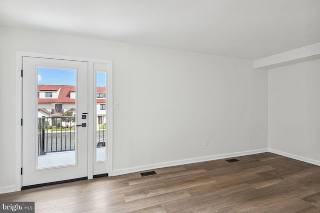 doorway to outside featuring hardwood / wood-style floors and a healthy amount of sunlight