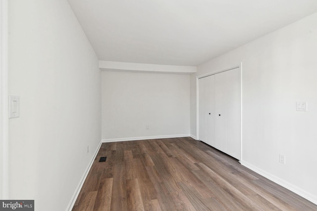 spare room with dark wood-type flooring