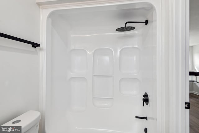 bathroom featuring hardwood / wood-style floors and toilet