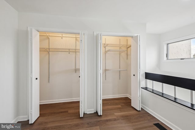 interior space featuring dark hardwood / wood-style flooring and a closet