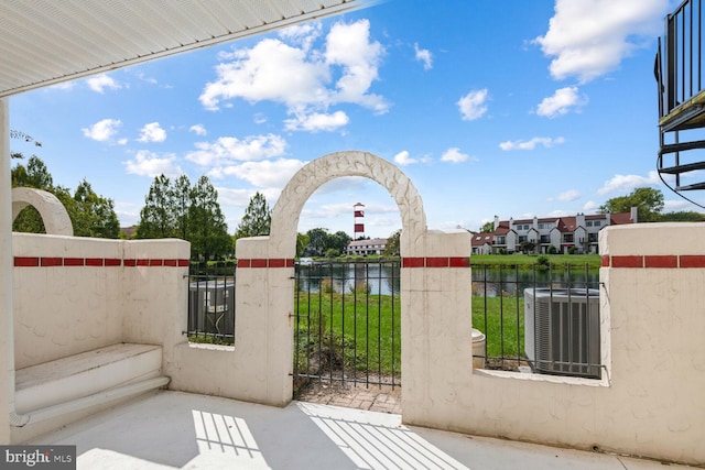 view of gate with central AC and a water view