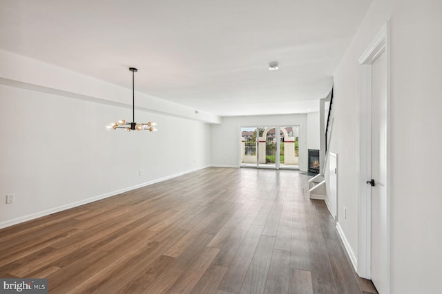 interior space with dark wood-type flooring and a chandelier