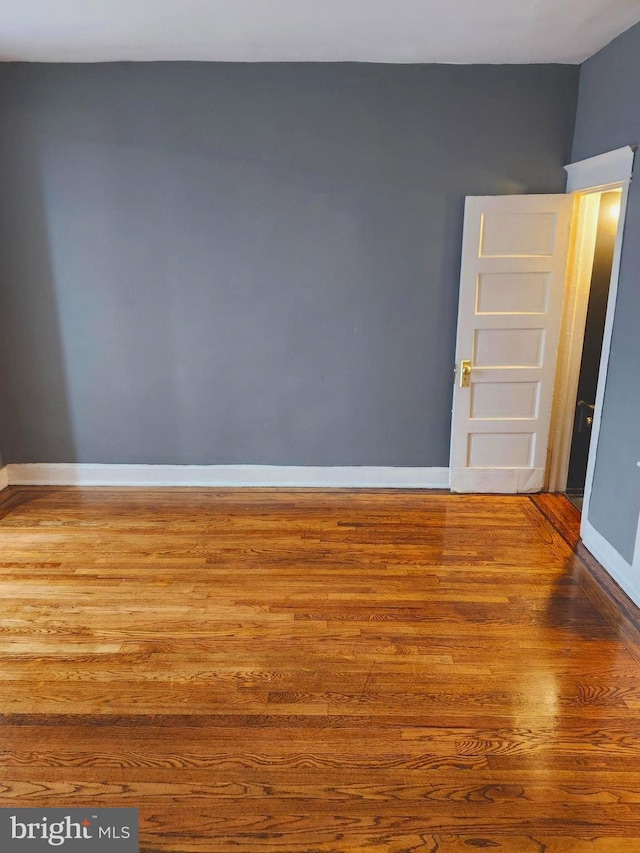 empty room with hardwood / wood-style floors