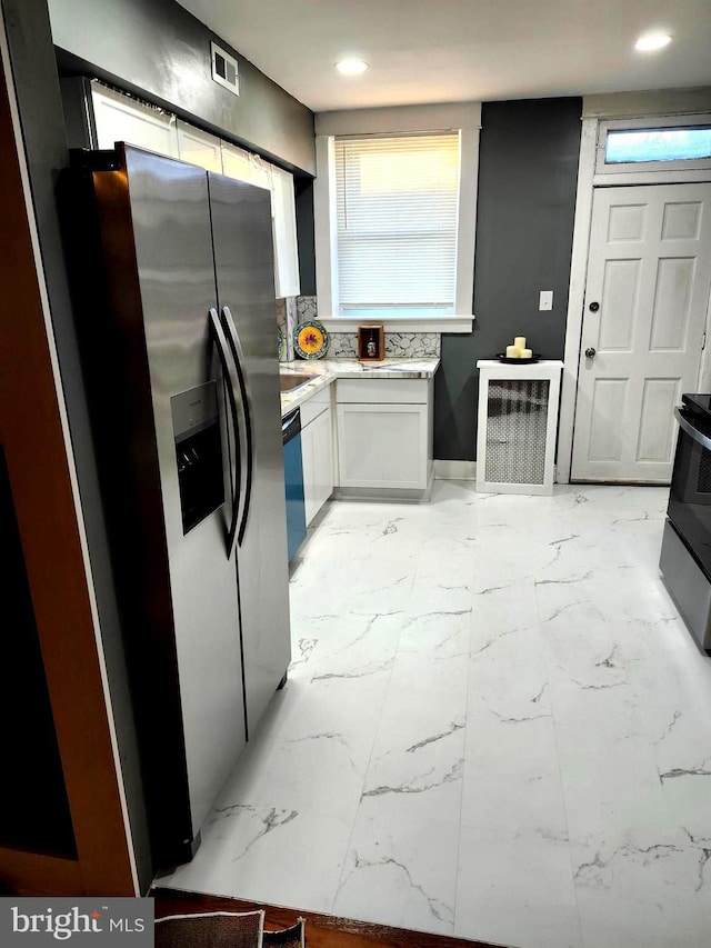 kitchen featuring white cabinetry and appliances with stainless steel finishes