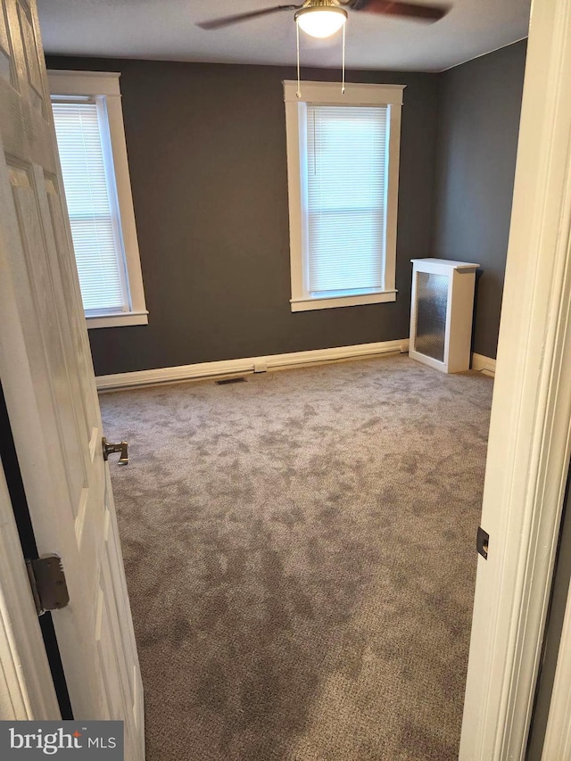 empty room featuring carpet and ceiling fan