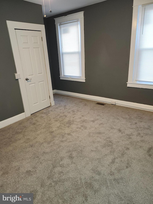 unfurnished room with carpet floors