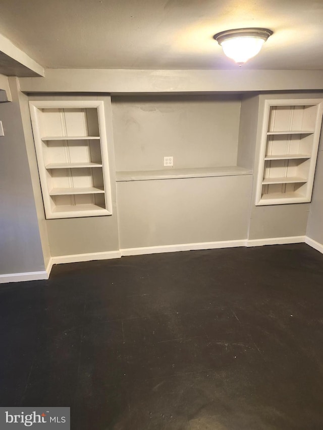 spare room featuring built in shelves