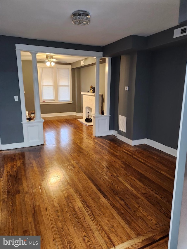 unfurnished living room featuring a fireplace, hardwood / wood-style floors, and ceiling fan