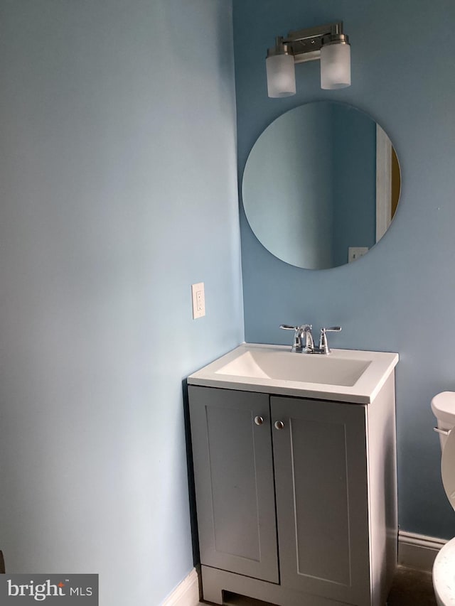 bathroom featuring toilet and vanity