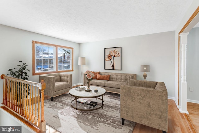 living room with light hardwood / wood-style flooring and a textured ceiling