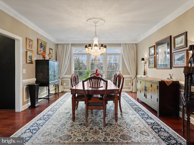 dining room with crown molding, dark hardwood / wood-style flooring, and a notable chandelier