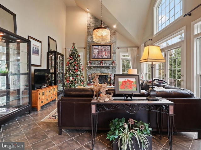 tiled living room featuring a fireplace and high vaulted ceiling