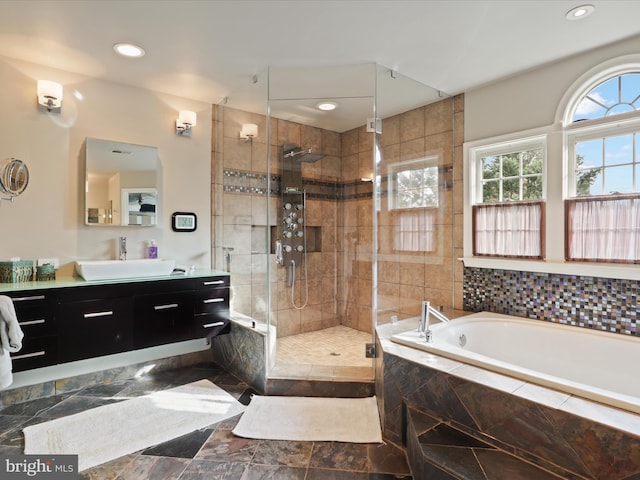 bathroom with vanity and shower with separate bathtub