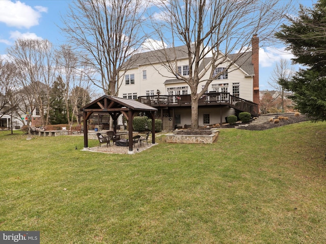 rear view of house with a gazebo, a yard, a deck, and a patio area