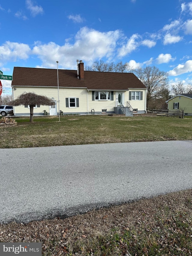 rear view of property featuring a lawn