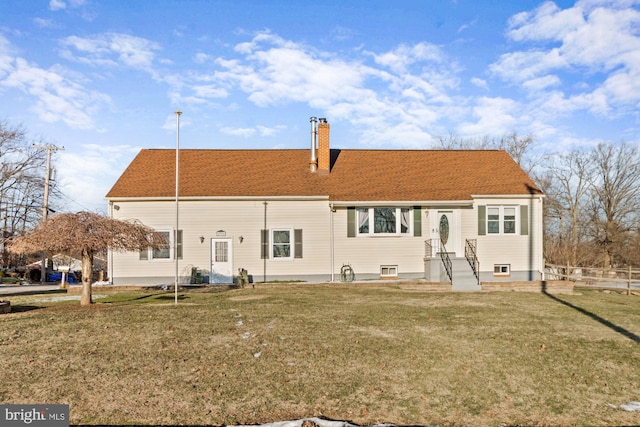 rear view of property with a yard