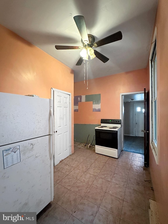 kitchen featuring ceiling fan and white appliances