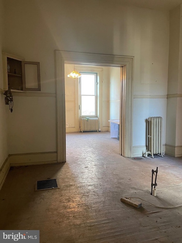 unfurnished room featuring radiator