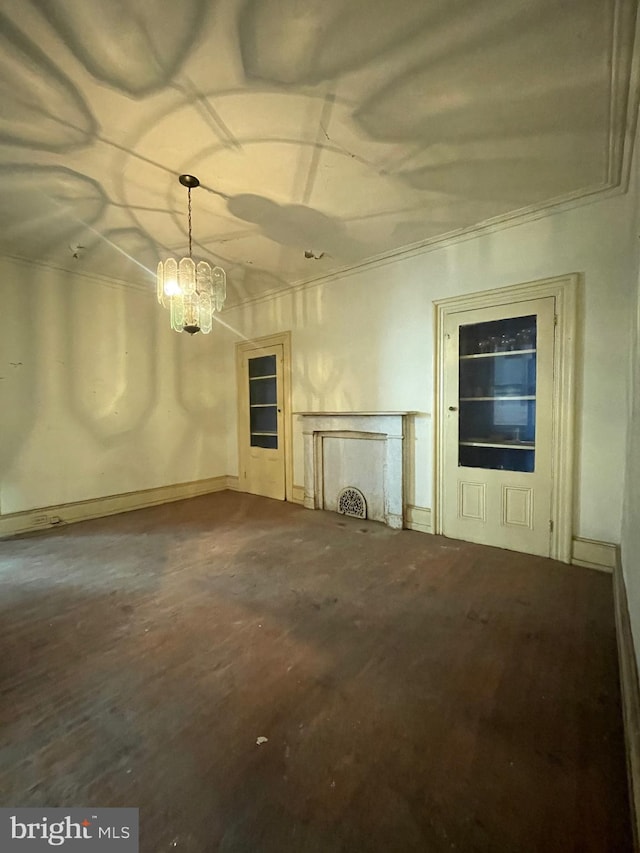 unfurnished living room with a chandelier and ornamental molding