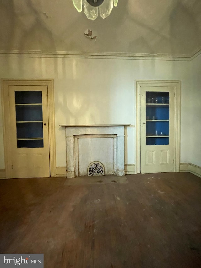 unfurnished living room with ornamental molding