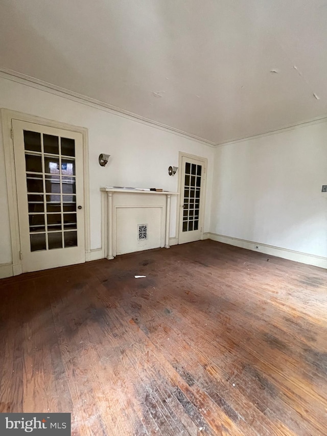 unfurnished living room with dark wood-type flooring and ornamental molding