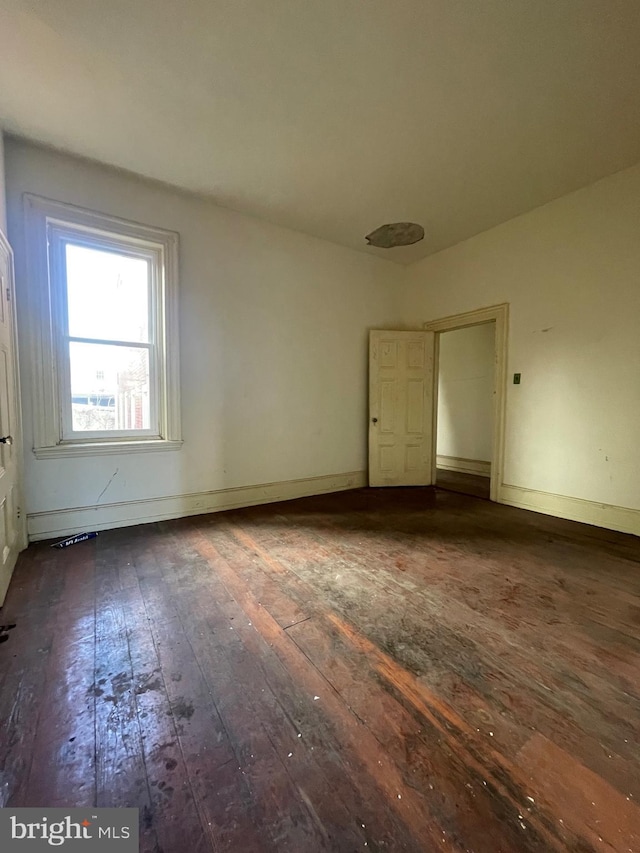 empty room with dark wood-type flooring