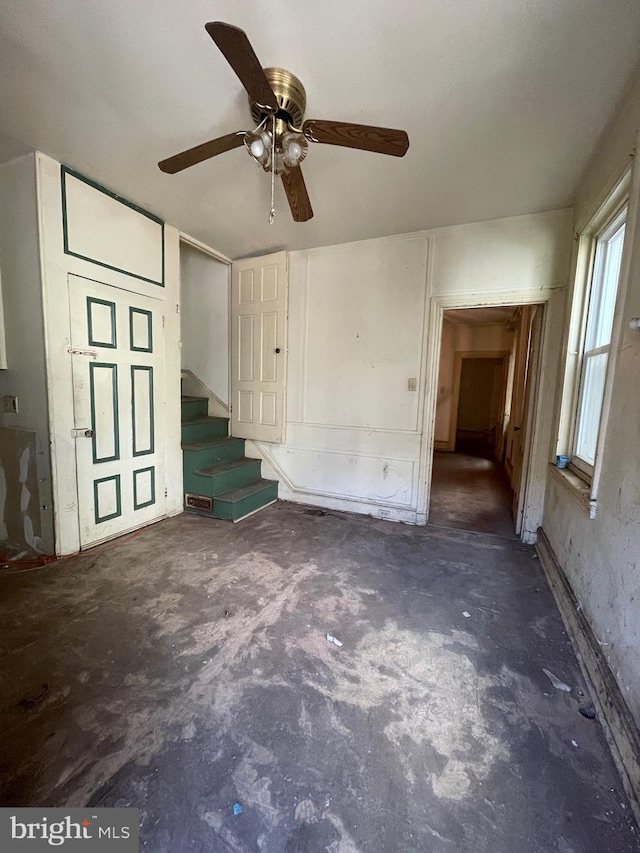 interior space with ceiling fan