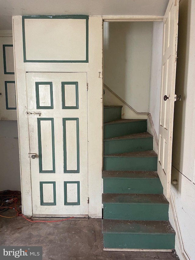 stairs featuring concrete floors