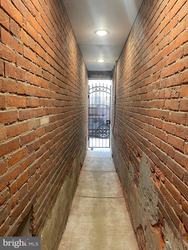 hallway with brick wall