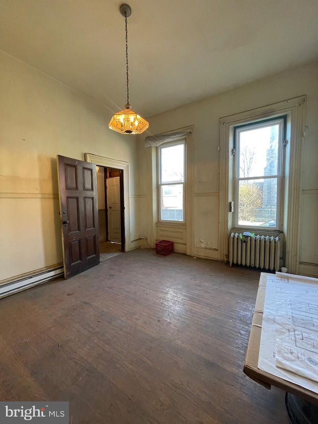 unfurnished dining area with radiator heating unit, dark hardwood / wood-style floors, and plenty of natural light