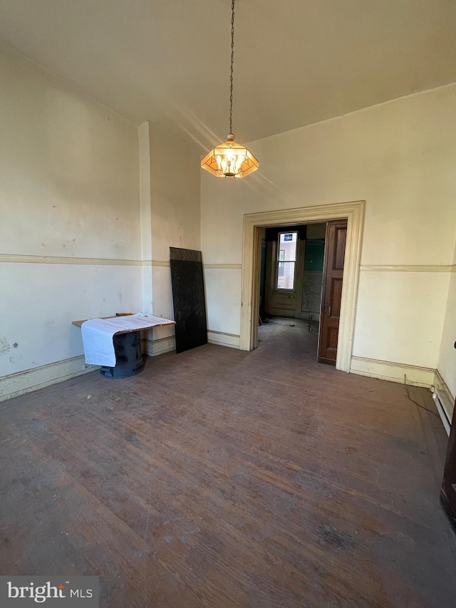 unfurnished dining area featuring dark hardwood / wood-style floors and vaulted ceiling