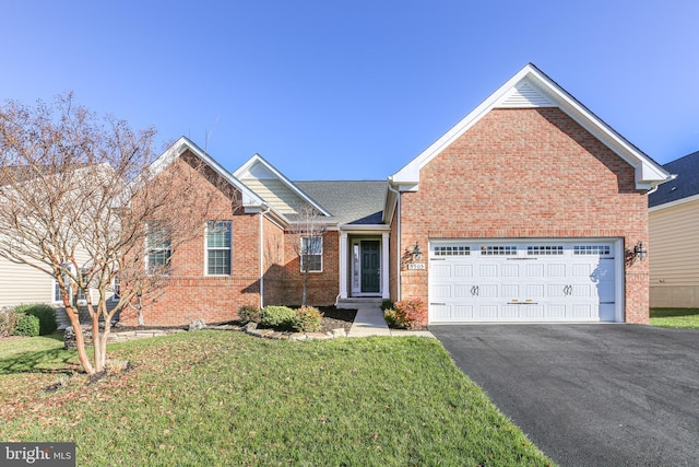 view of front of home featuring a front yard and a garage