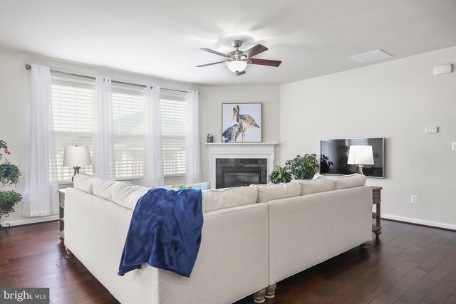 living room with ceiling fan and dark hardwood / wood-style floors