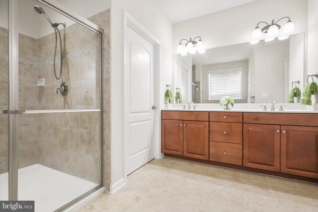 bathroom featuring tile patterned flooring, vanity, and an enclosed shower