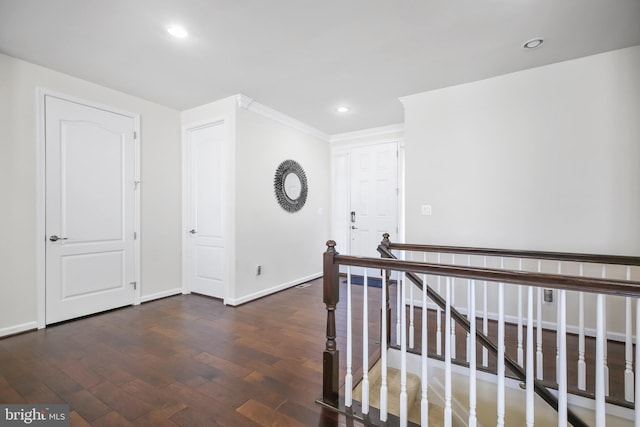 hall featuring dark hardwood / wood-style floors and crown molding