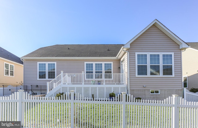 back of property with a wooden deck